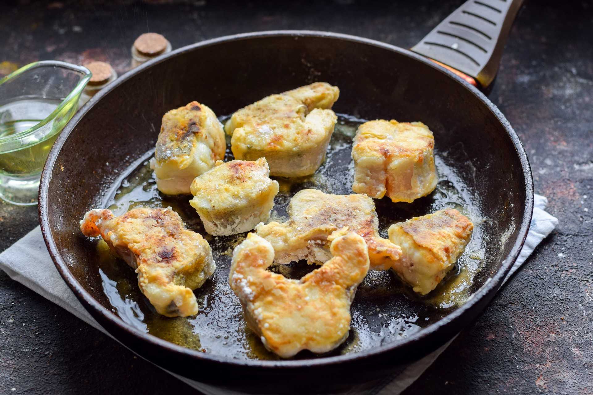 Жареный на сковороде хек с луком и морковью с томатной пастой